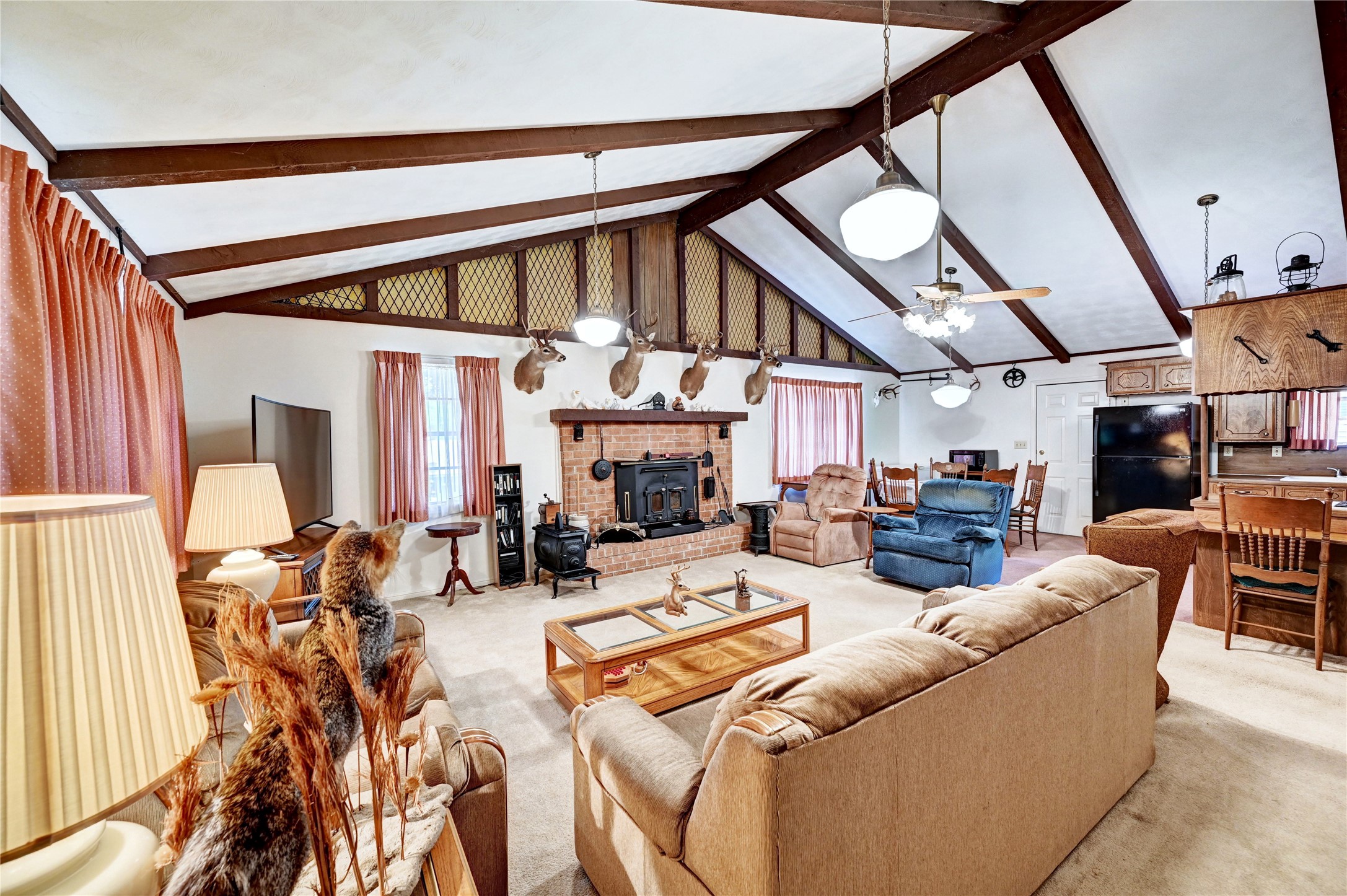 6 Hickory Hollow Road Huntsville, TX 77320 - Photo 18 of 44 a living room with furniture a fireplace and a large window