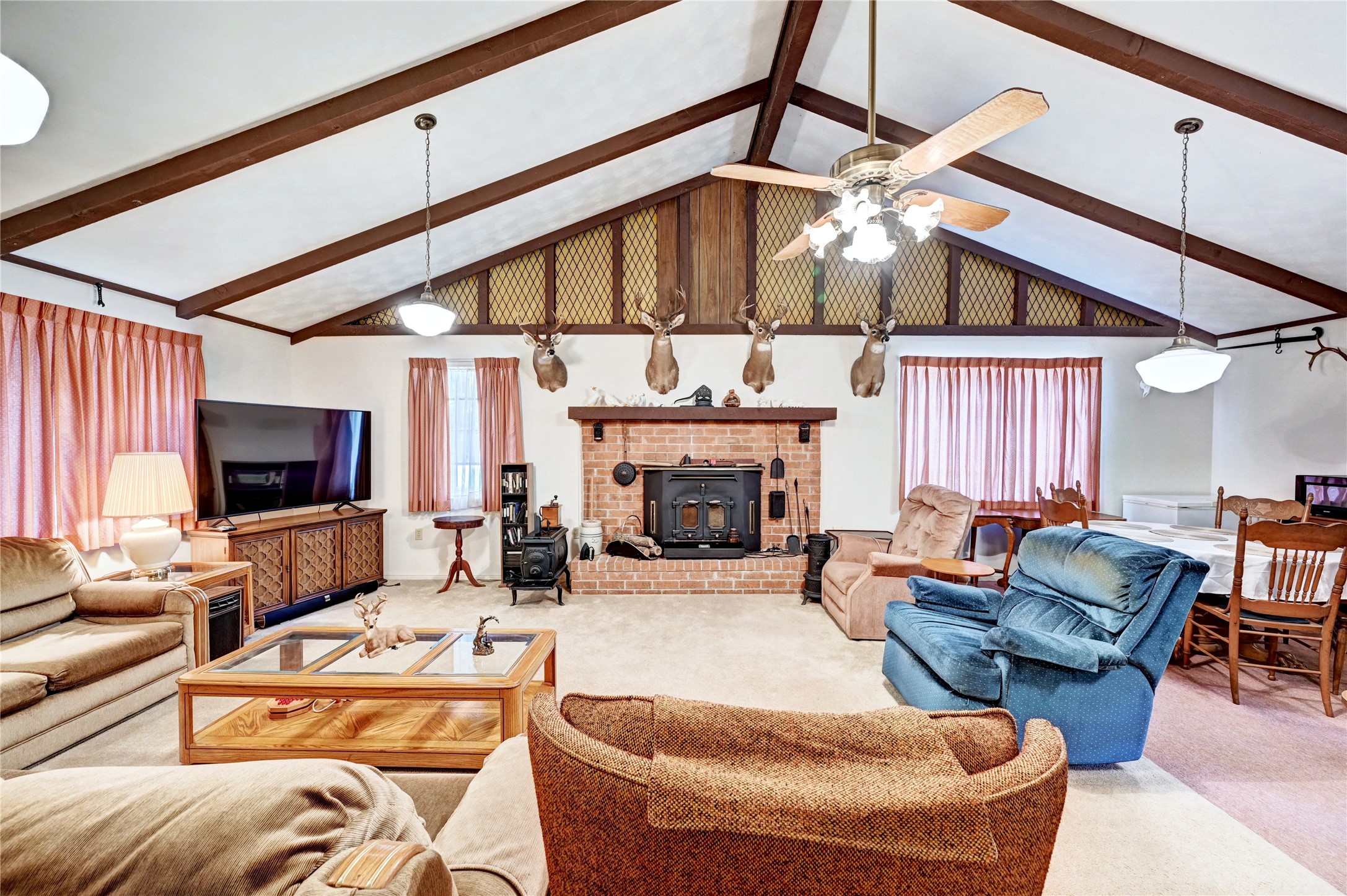 6 Hickory Hollow Road Huntsville, TX 77320 - Photo 20 of 44 a living room with furniture a fireplace and a flat screen tv
