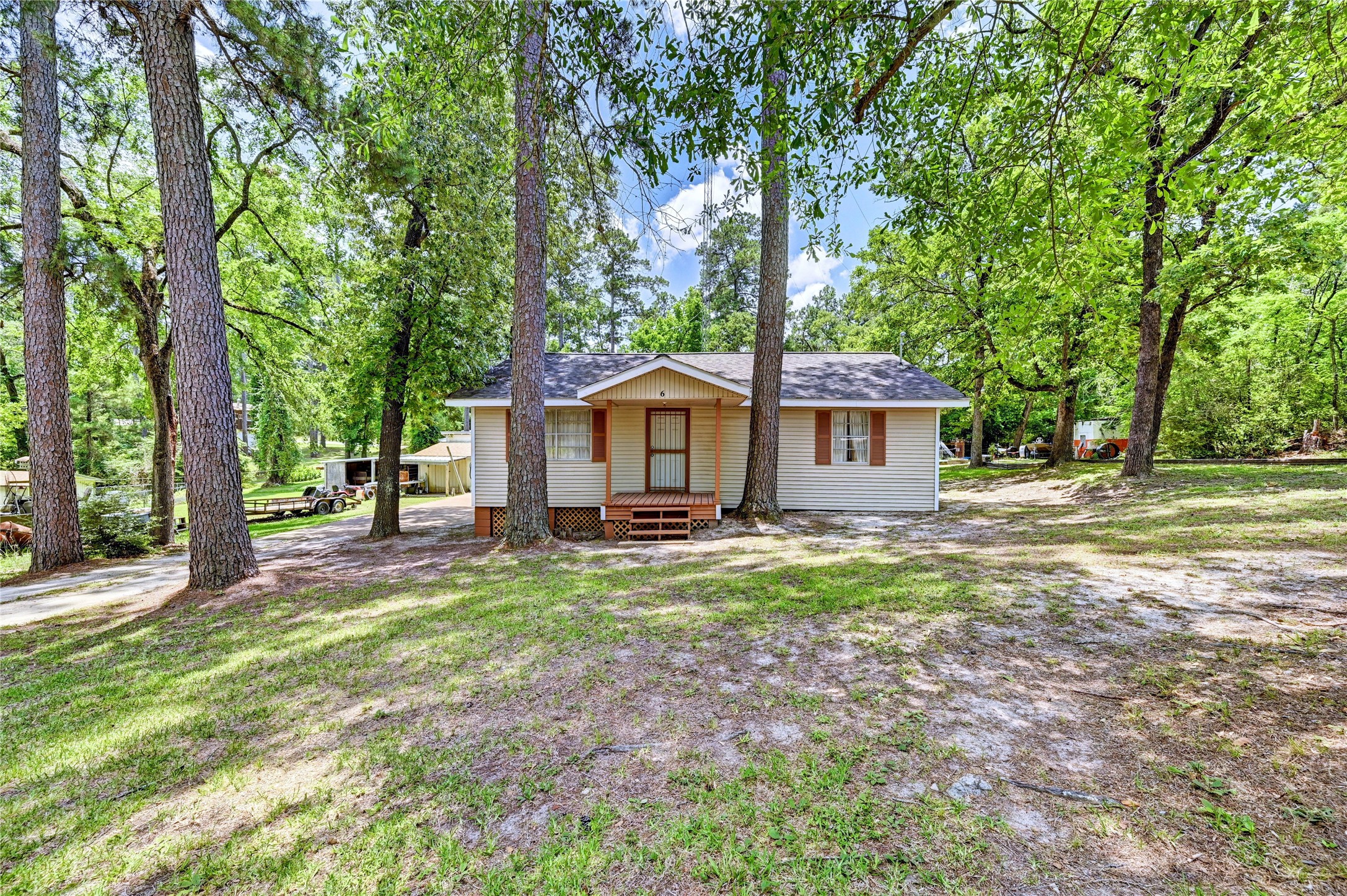 6 Hickory Hollow Road Huntsville, TX 77320 - Photo 2 of 44 a view of a house with backyard and a tree