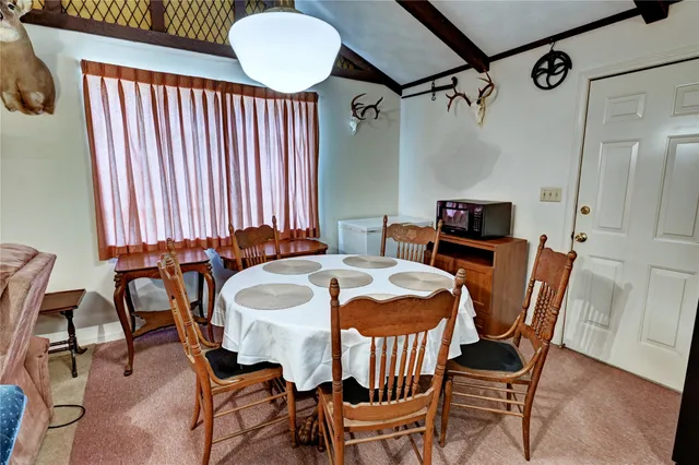 a dining room with furniture and window