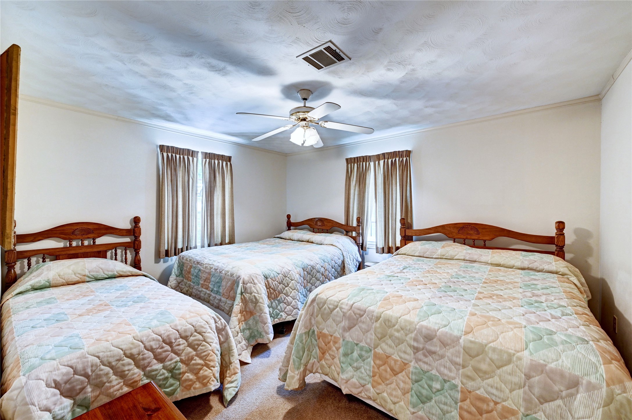 6 Hickory Hollow Road Huntsville, TX 77320 - Photo 31 of 44 a bedroom with two beds and a chandelier