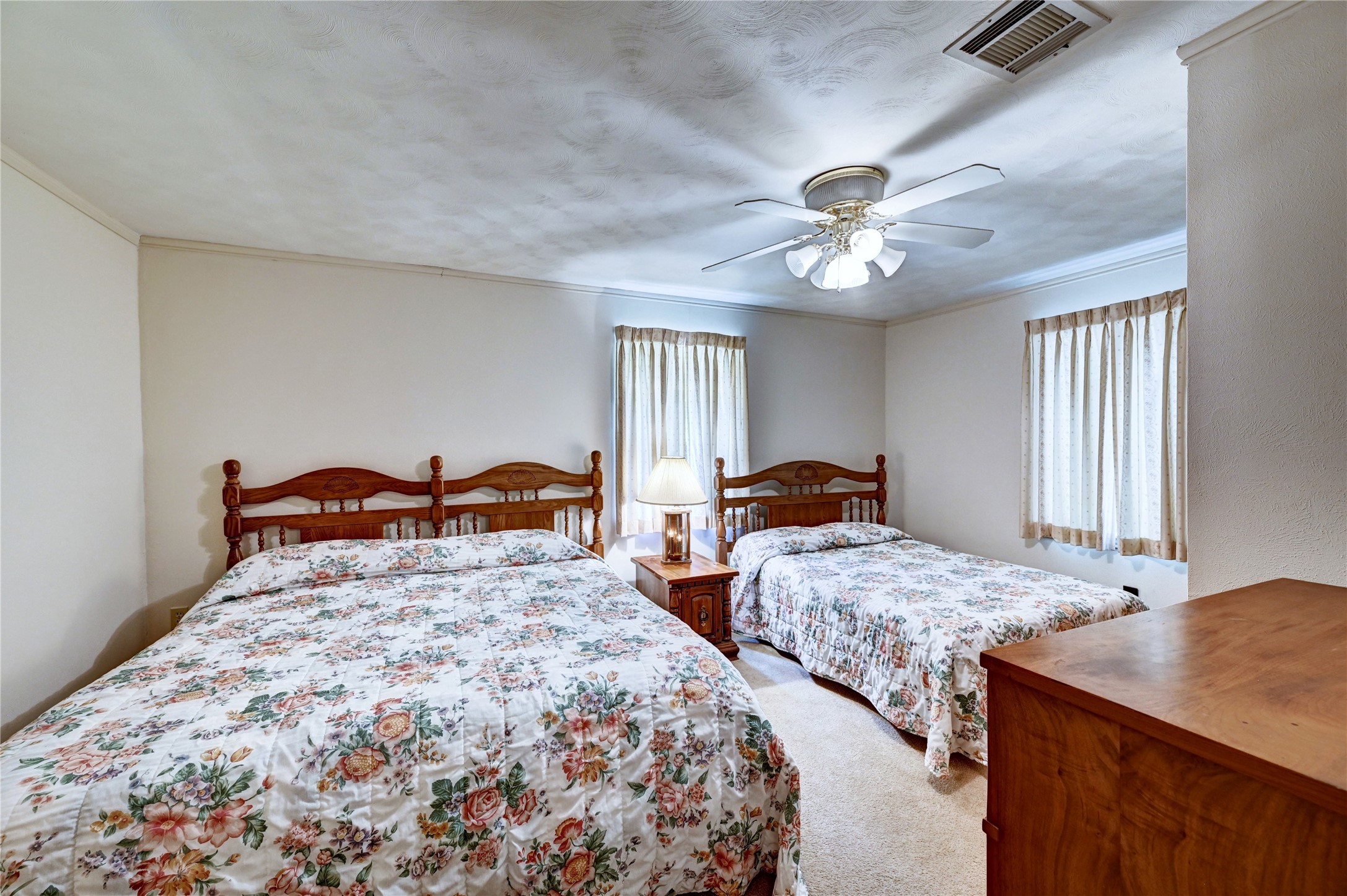 6 Hickory Hollow Road Huntsville, TX 77320 - Photo 34 of 44 a bedroom with two beds and a chandelier