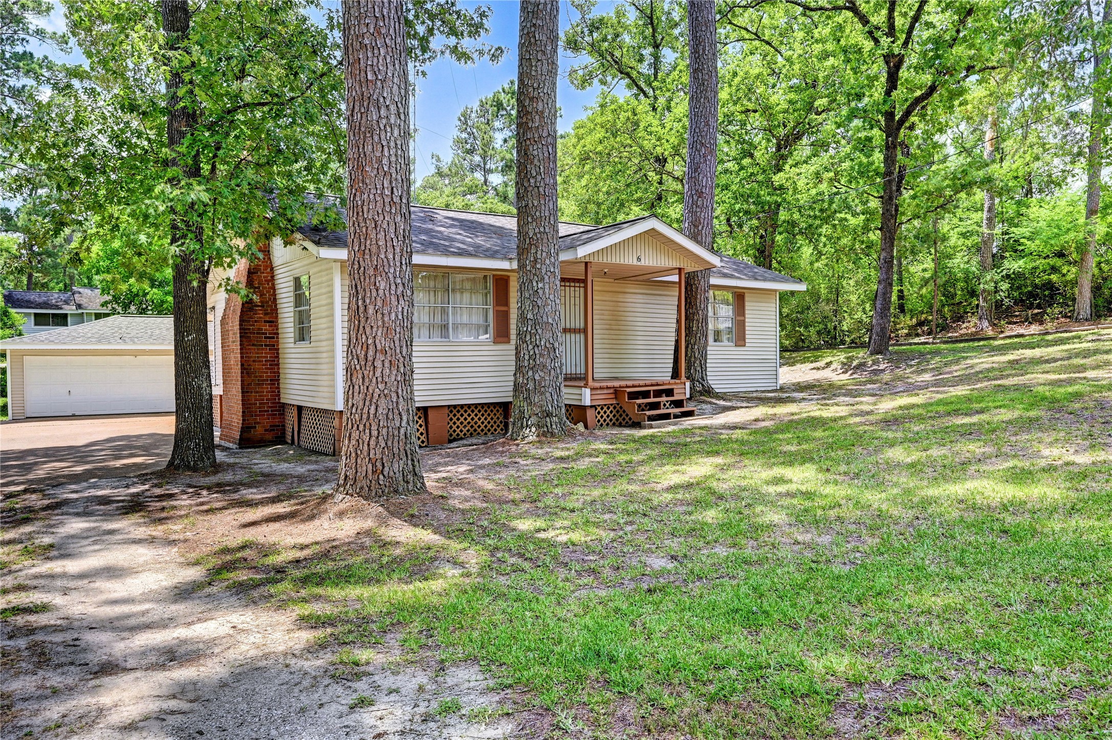 6 Hickory Hollow Road Huntsville, TX 77320 - Photo 4 of 44 a view of a house with backyard and a tree