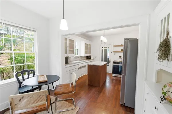 a living room with furniture a fireplace and a large window
