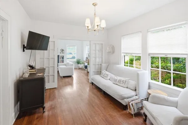 a bedroom with a bed and a chandelier