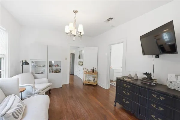 a bedroom with bed and a chandelier
