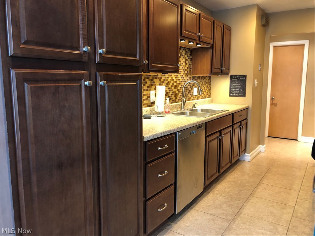 4851 South Sedgewick Road Cleveland, OH 44124 - Photo 2 of 26 Cherry cabinets with loads of storage, under cabinet lighting and tile backsplash!