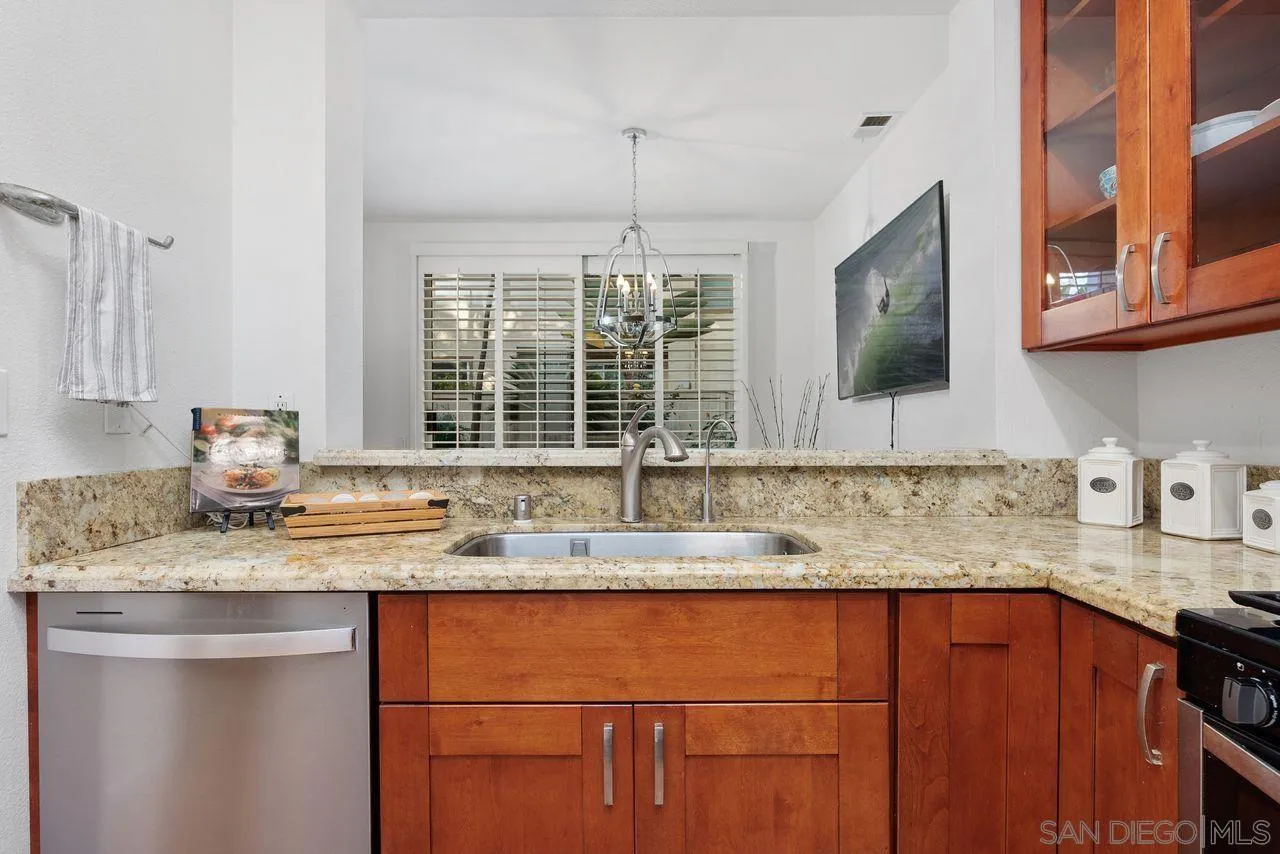 3965 Via Holgura San Diego, CA 92130 - Photo 13 of 45 a kitchen with granite countertop cabinets sink and window