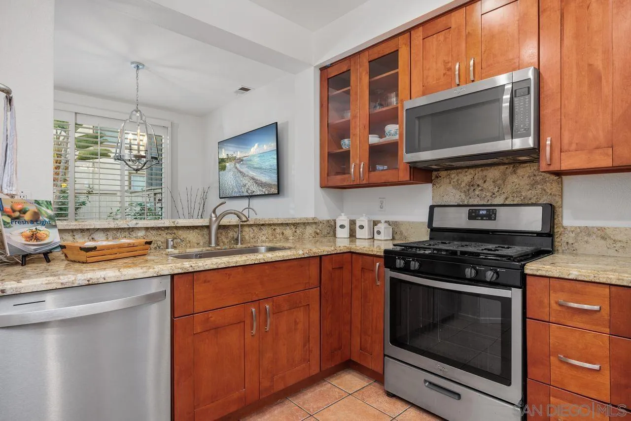 3965 Via Holgura San Diego, CA 92130 - Photo 14 of 45 a kitchen with stainless steel appliances a stove sink and microwave