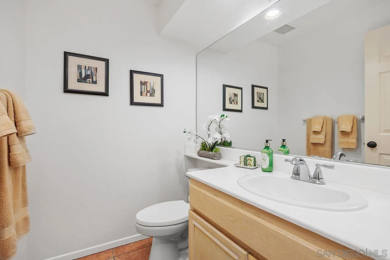 3965 Via Holgura San Diego, CA 92130 - Photo 16 of 45 a bathroom with a granite countertop sink and a toilet