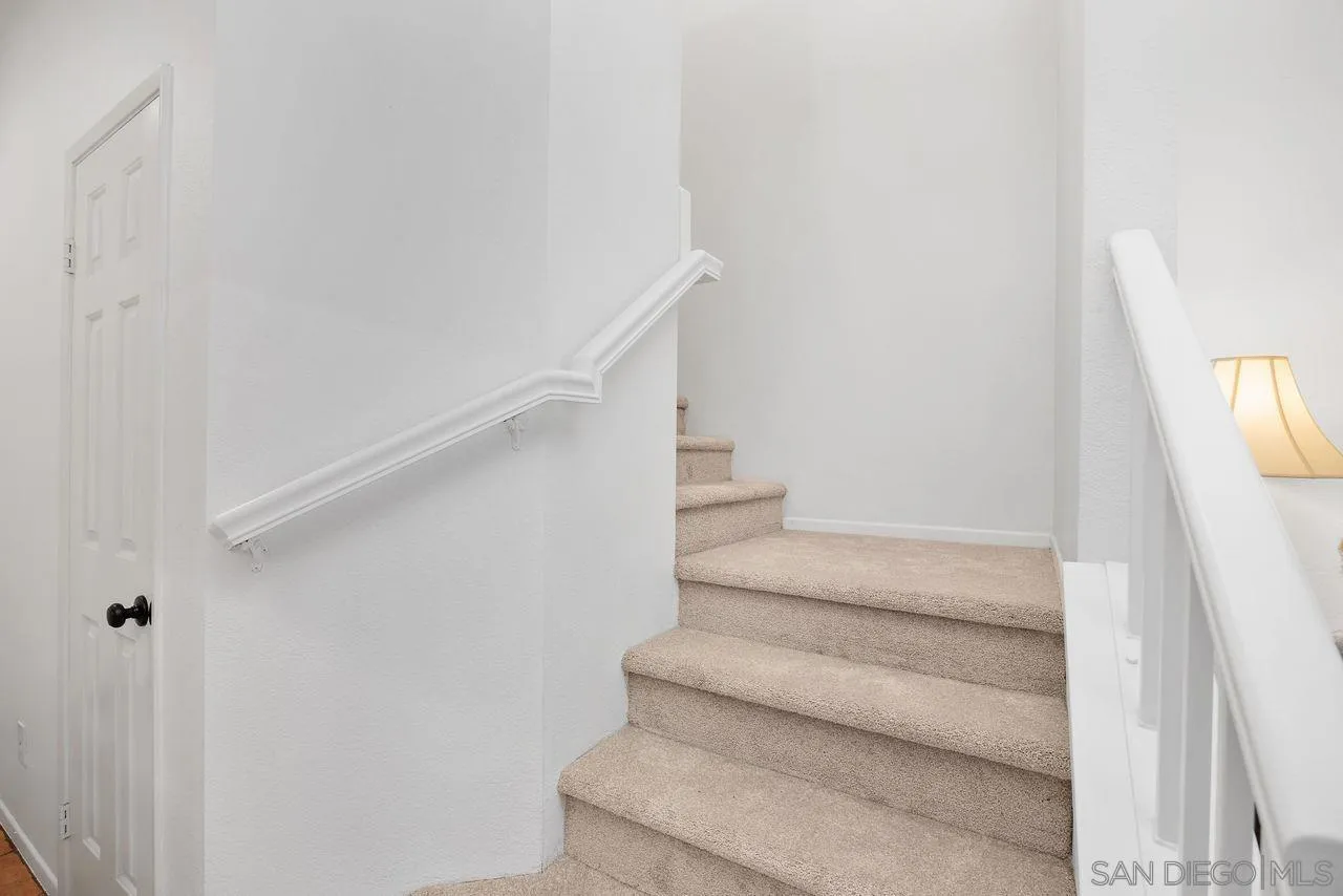 3965 Via Holgura San Diego, CA 92130 - Photo 17 of 45 a view of staircase with white walls