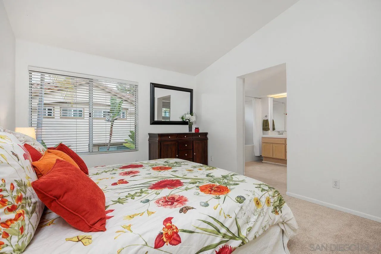3965 Via Holgura San Diego, CA 92130 - Photo 21 of 45 a bedroom with a bed and a flat screen tv