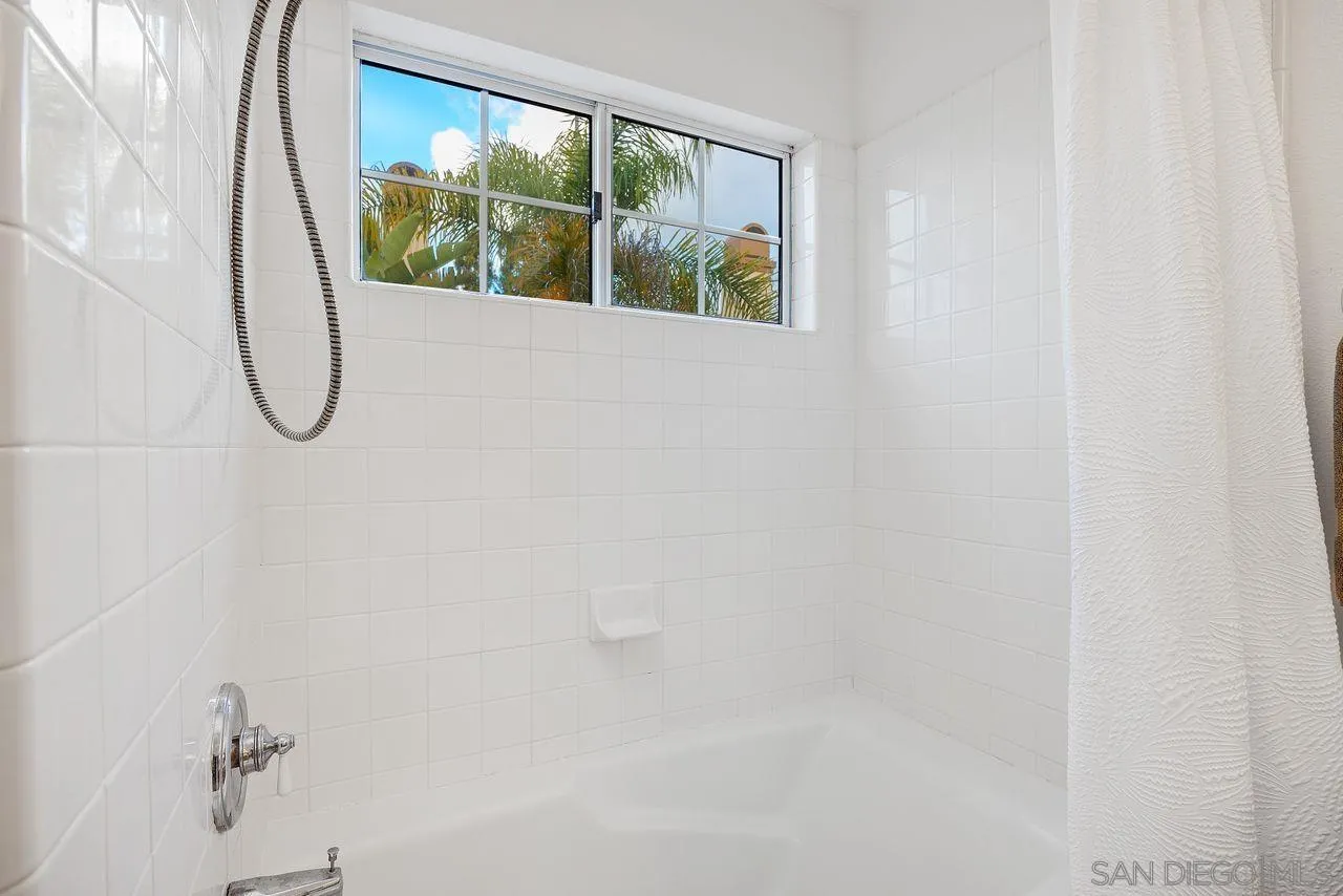 3965 Via Holgura San Diego, CA 92130 - Photo 23 of 45 a bathroom with a glass shower door