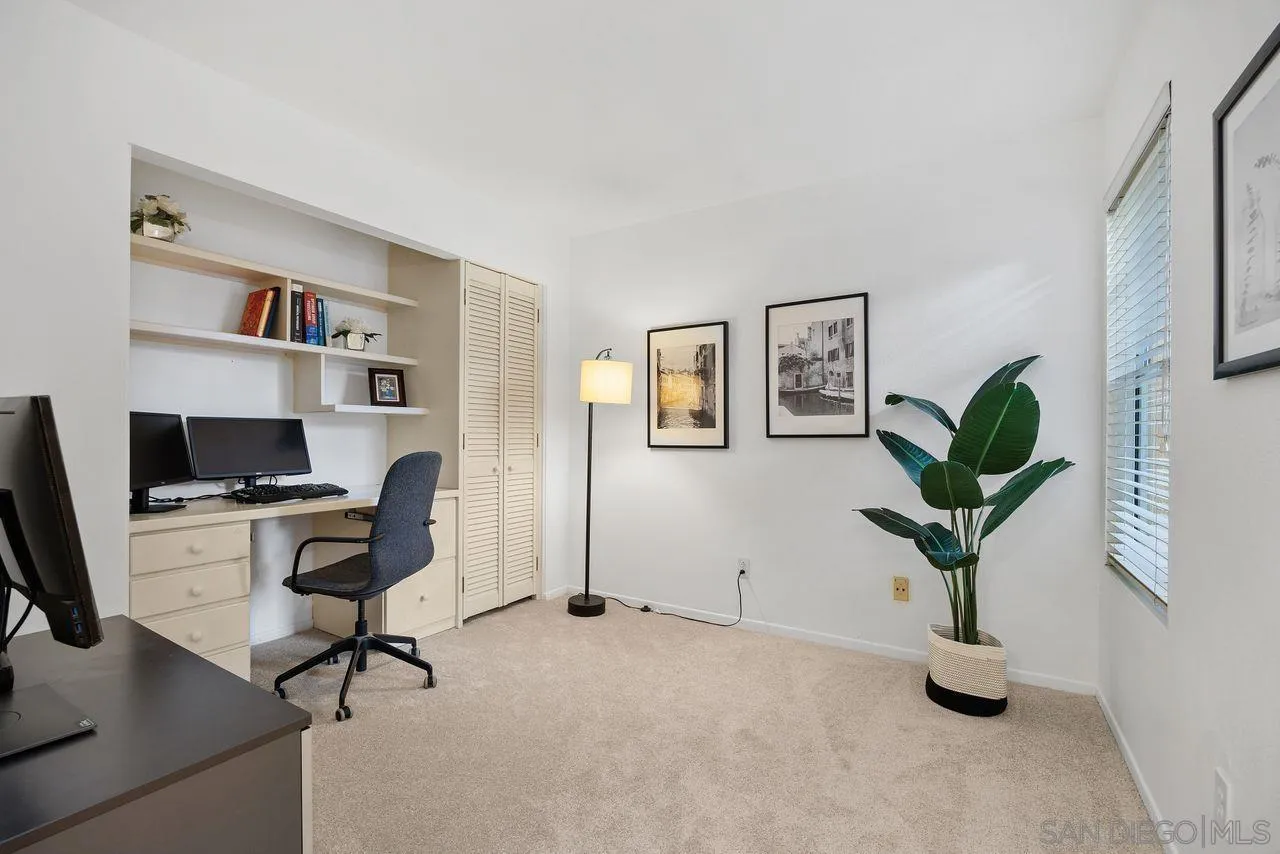 3965 Via Holgura San Diego, CA 92130 - Photo 27 of 45 a view of a workspace with a potted plant