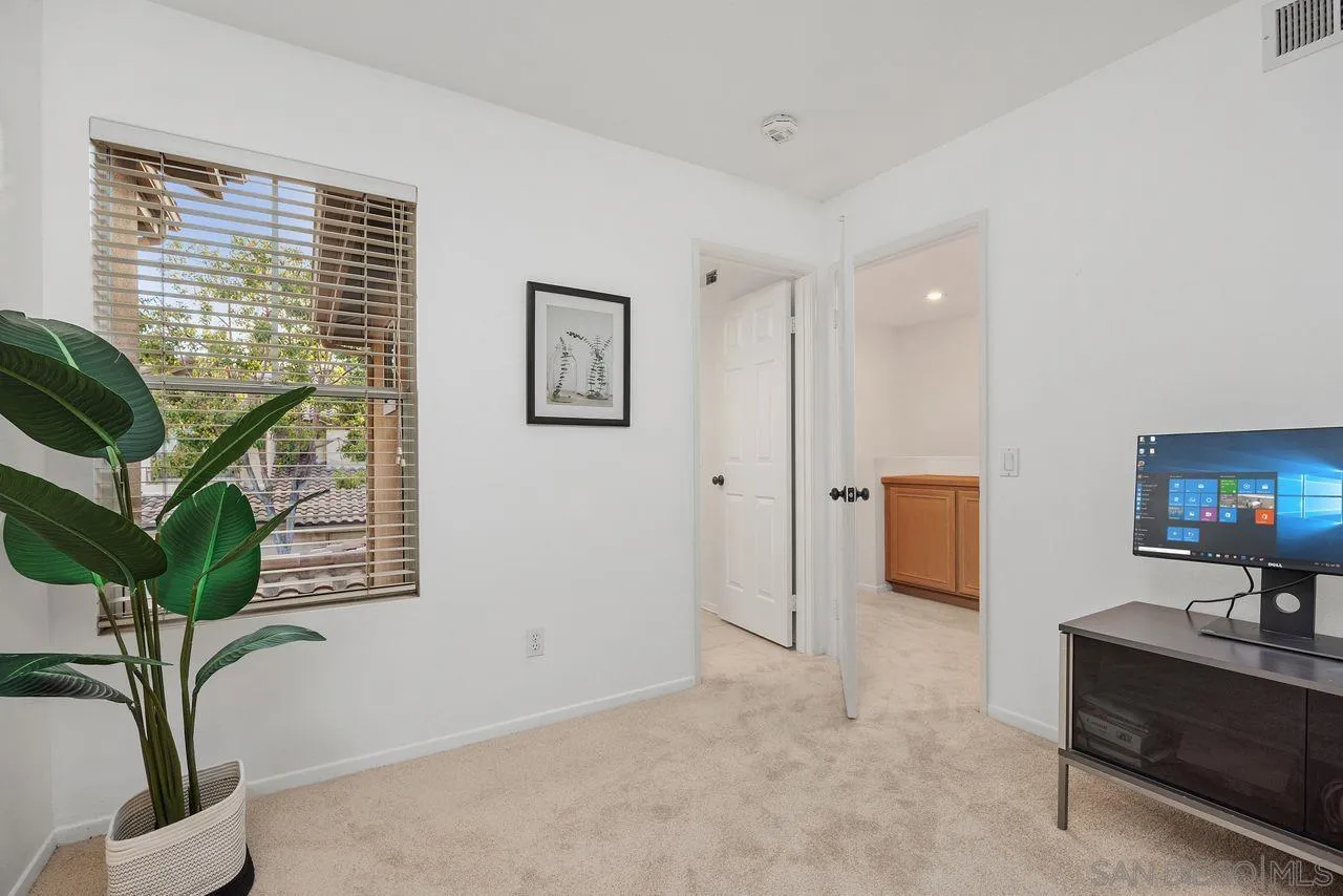3965 Via Holgura San Diego, CA 92130 - Photo 28 of 45 a living room with furniture and a potted plant