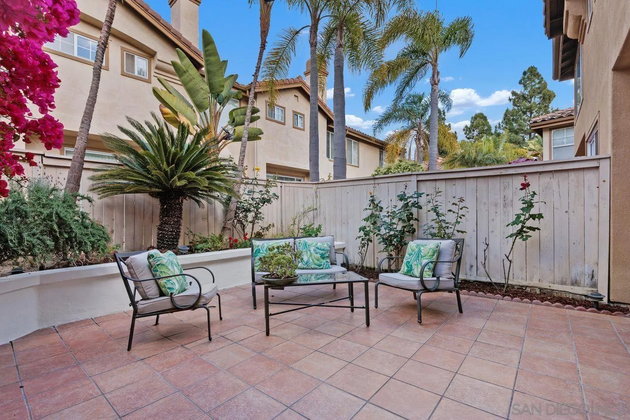 3965 Via Holgura San Diego, CA 92130 - Photo 29 of 45 a view of a chairs and table in the back yard of the house