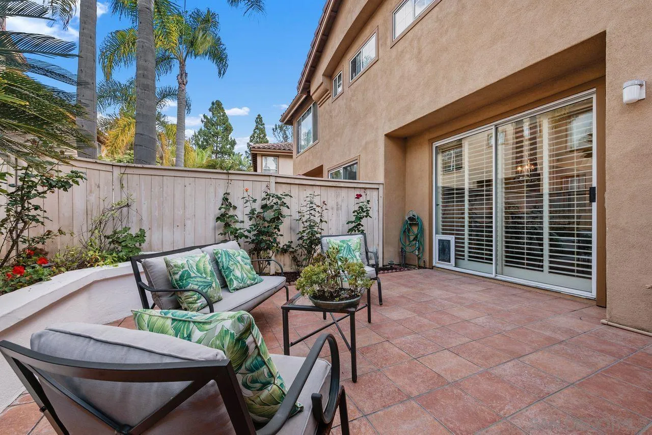 3965 Via Holgura San Diego, CA 92130 - Photo 31 of 45 a view of a chairs and table in the back yard of the house
