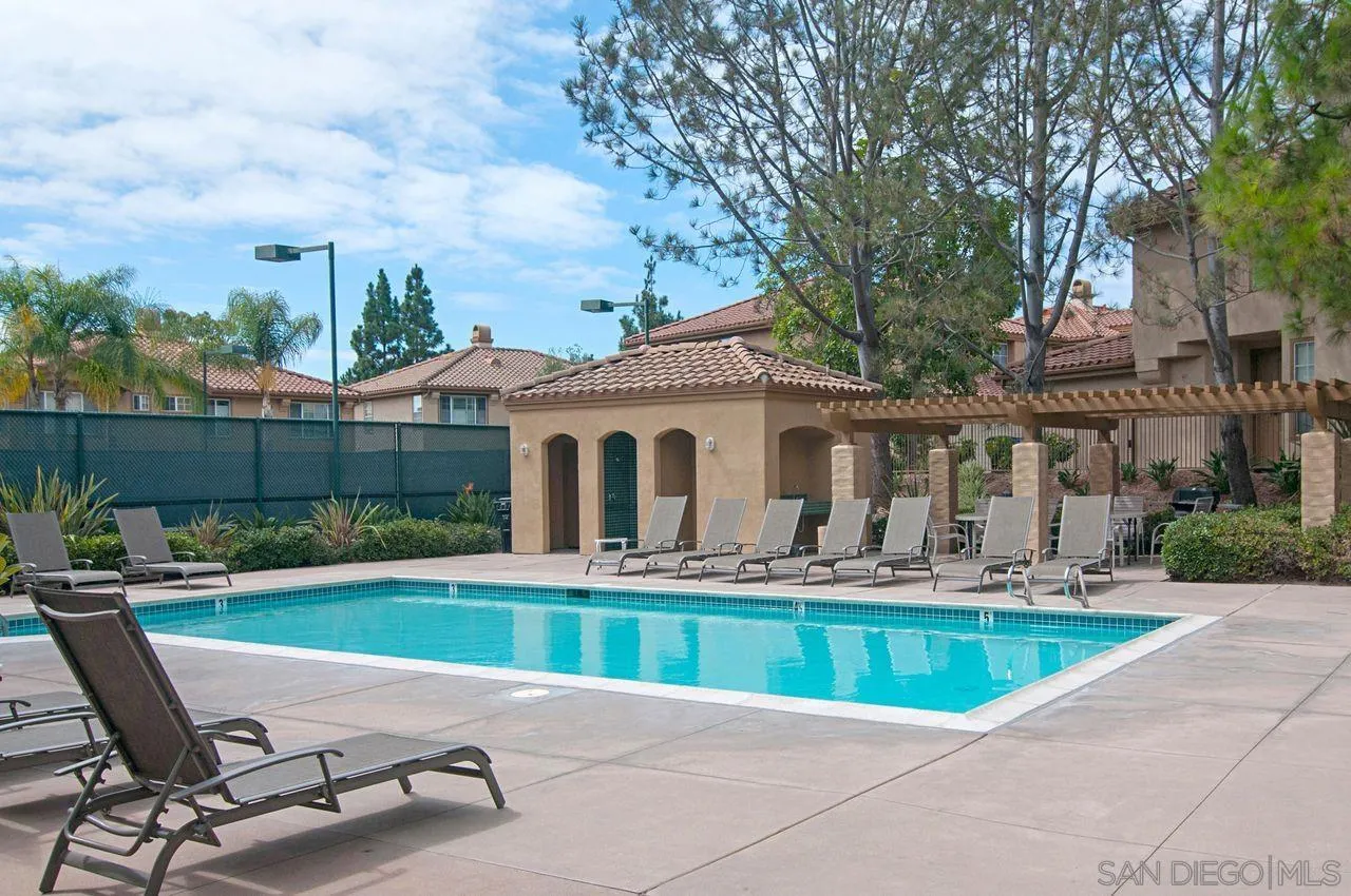 3965 Via Holgura San Diego, CA 92130 - Photo 33 of 45 a view of house with swimming pool and outdoor seating