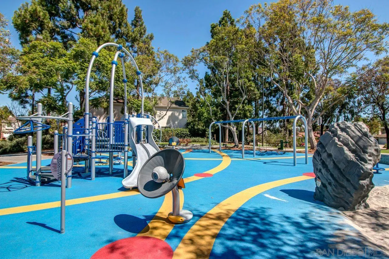 3965 Via Holgura San Diego, CA 92130 - Photo 40 of 45 a view of a swimming pool with a bench
