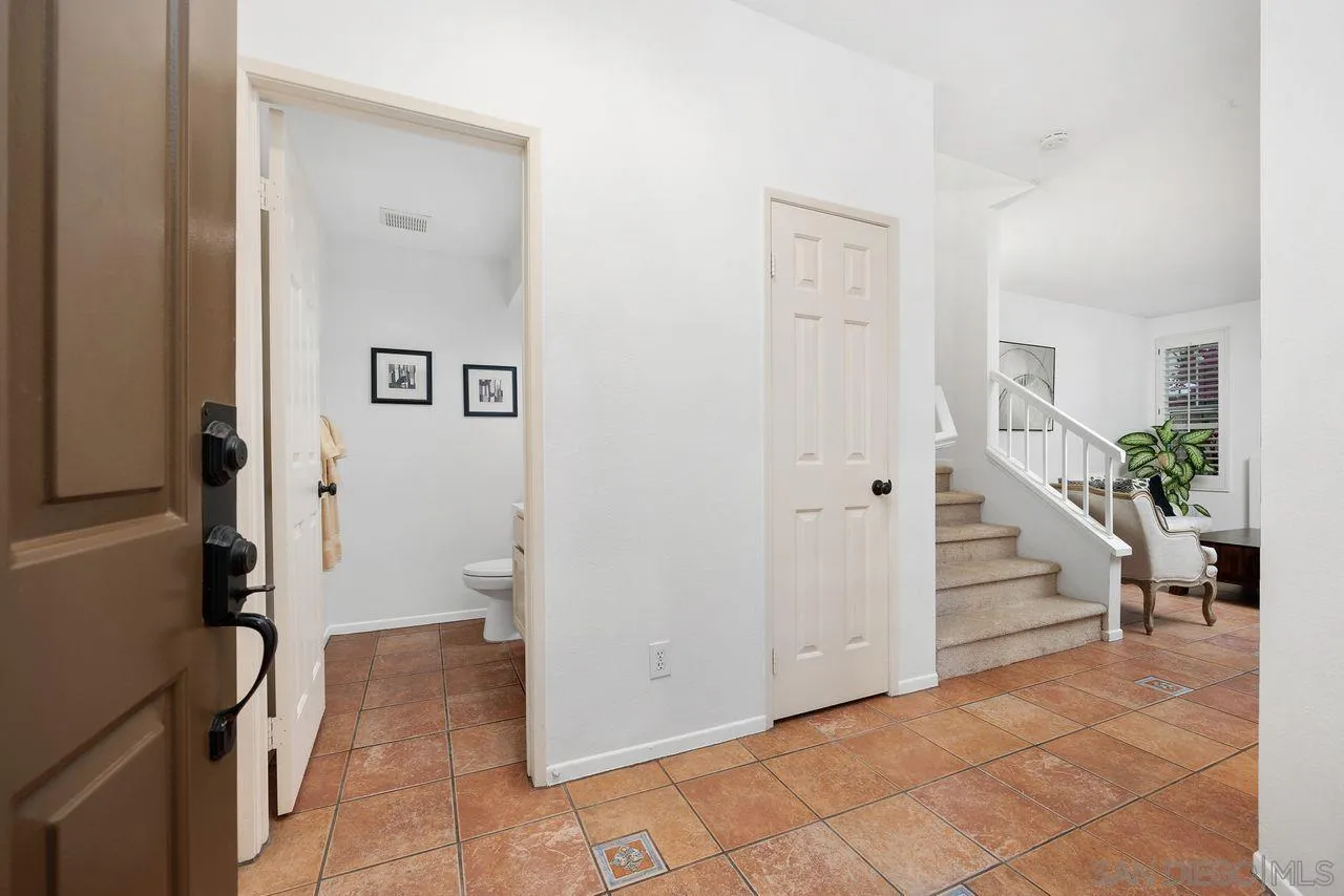3965 Via Holgura San Diego, CA 92130 - Photo 44 of 45 a view of entryway with wooden floor and stairs