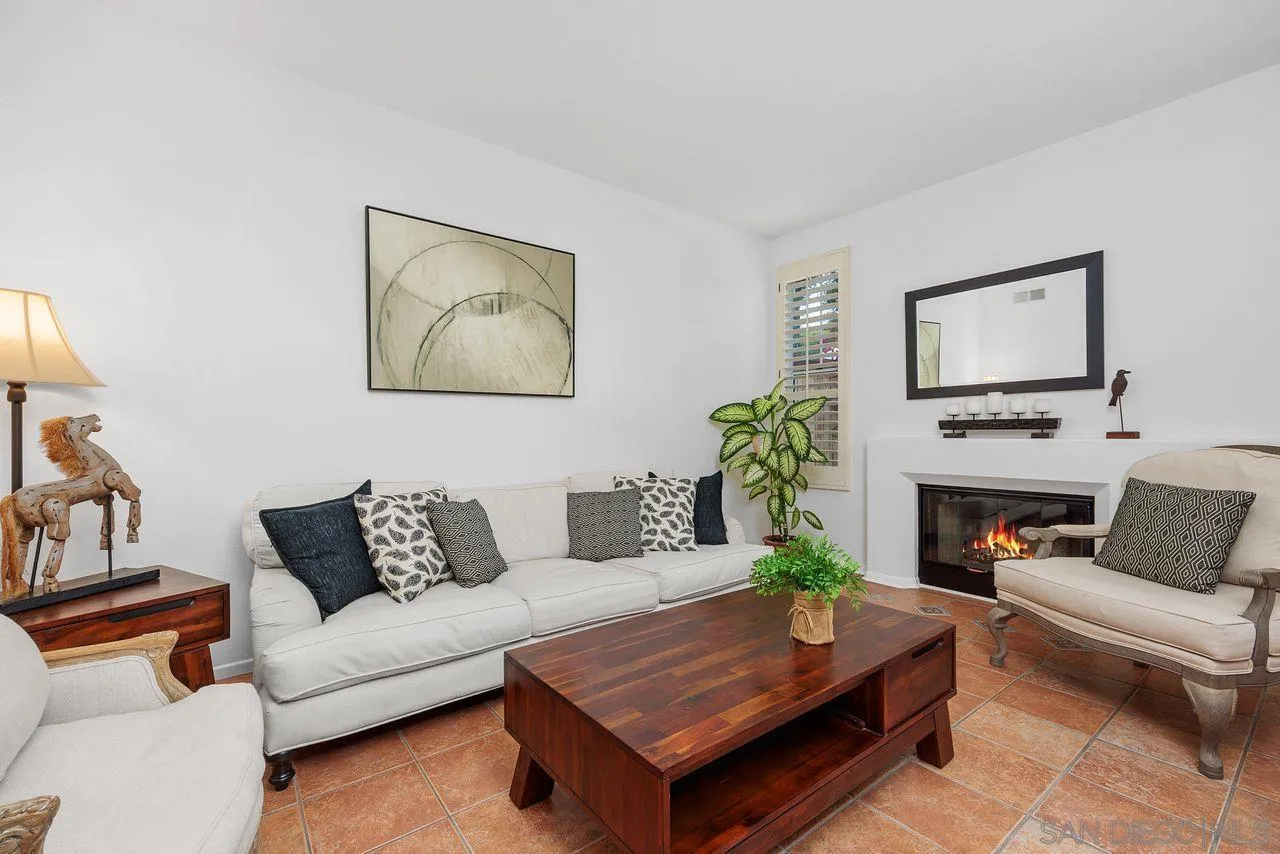 3965 Via Holgura San Diego, CA 92130 - Photo 7 of 45 a living room with furniture a fireplace and a flat screen tv