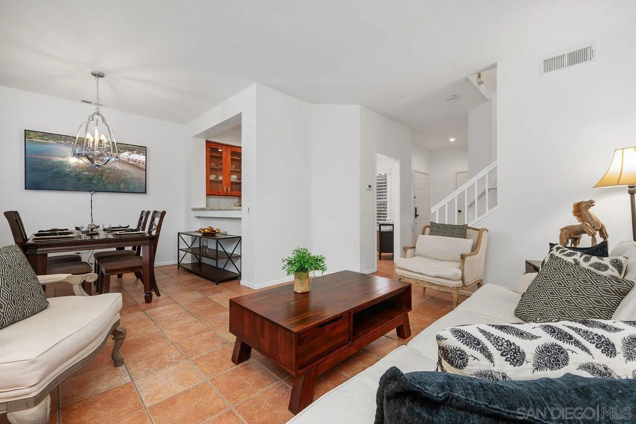 3965 Via Holgura San Diego, CA 92130 - Photo 8 of 45 a living room with furniture and a flat screen tv
