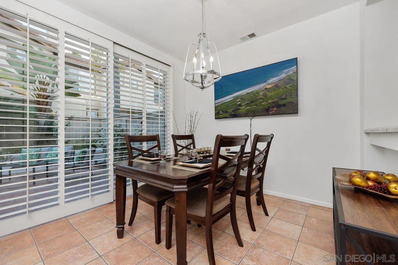 3965 Via Holgura San Diego, CA 92130 - Photo 9 of 45 a view of a dining room with furniture and chandelier