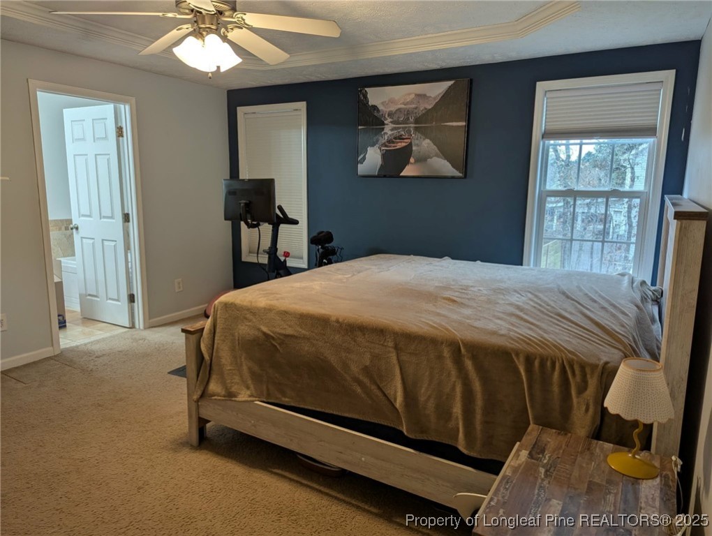 45 Copper Loop Sanford, NC 27332 - Photo 11 of 30 a bedroom with a bed and a chandelier
