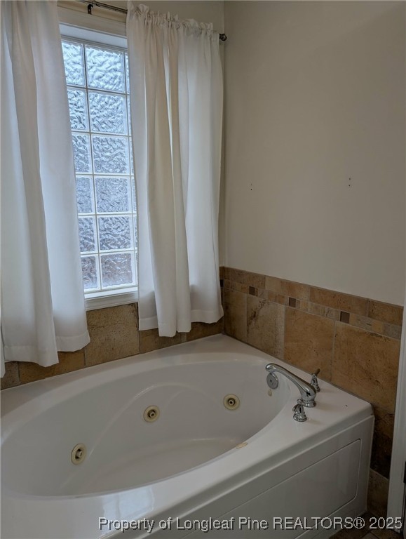 45 Copper Loop Sanford, NC 27332 - Photo 14 of 30 a bathroom with a tub a sink and a window