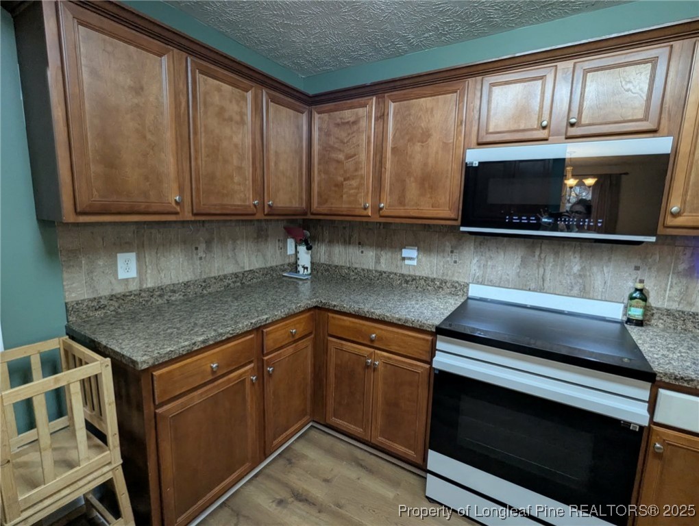 45 Copper Loop Sanford, NC 27332 - Photo 6 of 30 a kitchen with stainless steel appliances granite countertop a sink stove and cabinets