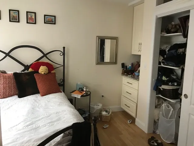 a bedroom with a bed and a cabinets