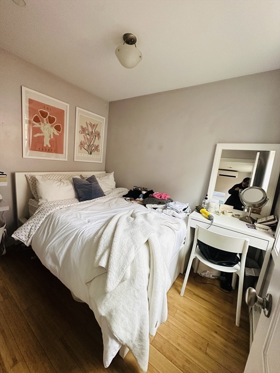 6 Baldwin Place Boston, MA 02113 - Photo 3 of 16 a bedroom with a bed and wooden floor