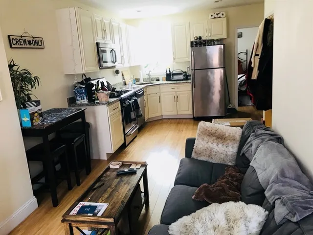 a kitchen with stainless steel appliances granite countertop a refrigerator a stove and a refrigerator