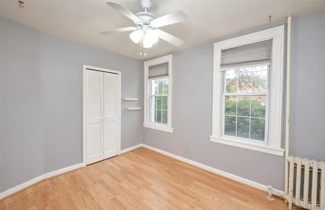 wooden floor in an empty room with a window