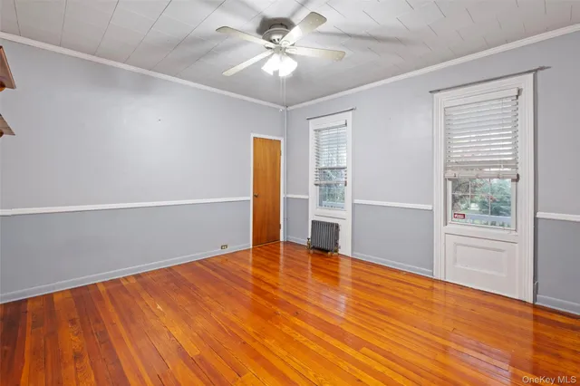 a kitchen with stainless steel appliances granite countertop a refrigerator a sink a oven with a dining table and a large window