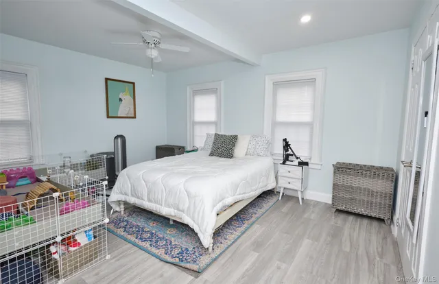 a bedroom with furniture and a wooden floor