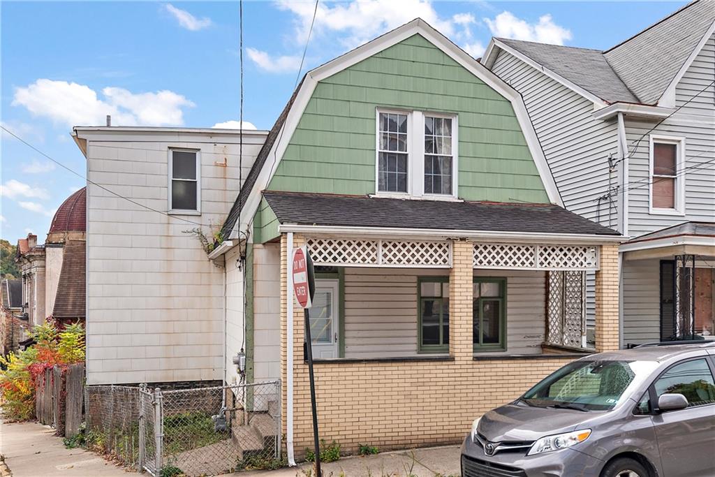 a front view of a house with parking