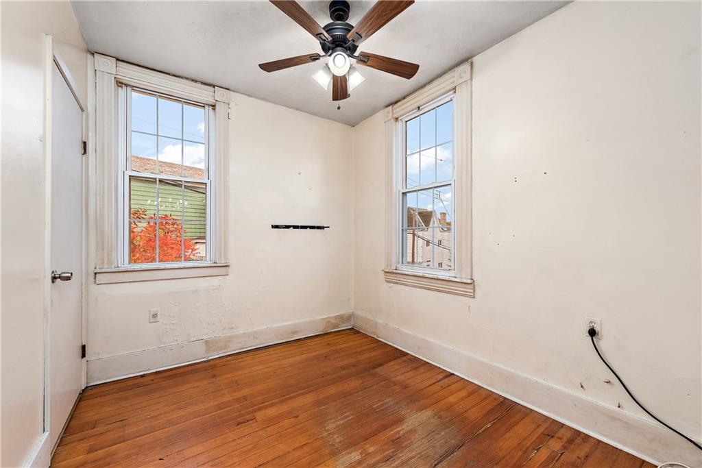 801 Frank Street McKees Rocks, PA 15136 - Photo 12 of 25 a view of an empty room with a window and wooden floor
