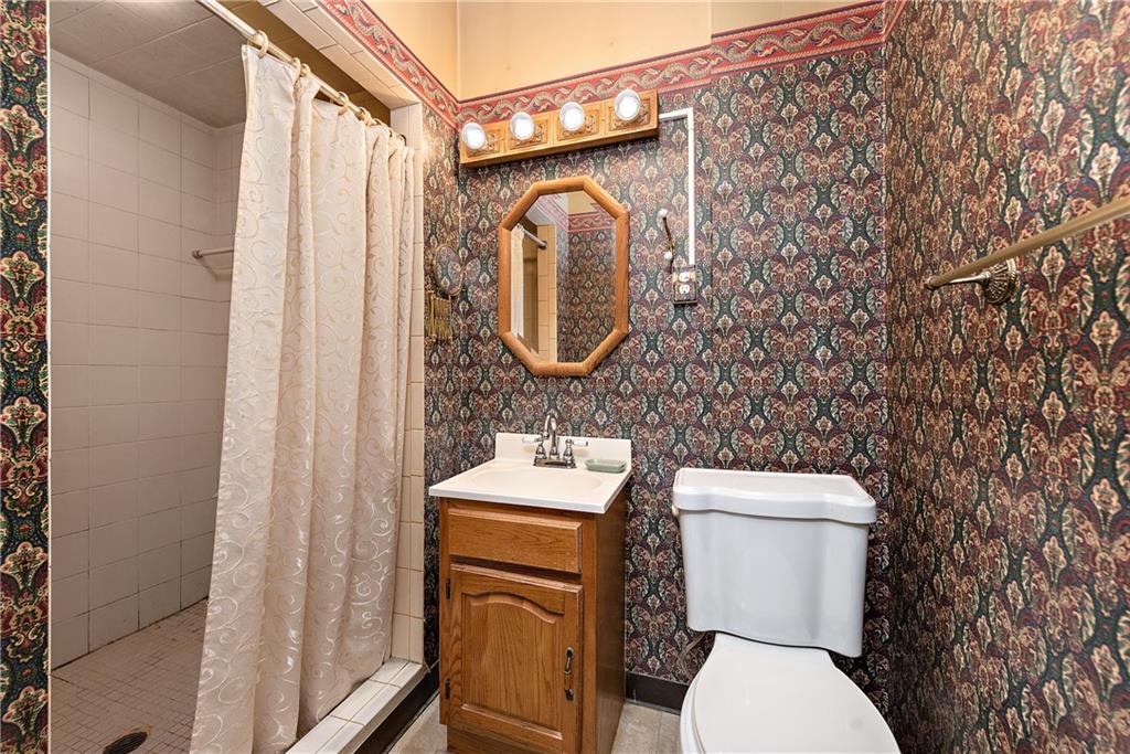 801 Frank Street McKees Rocks, PA 15136 - Photo 14 of 25 a white toilet sitting next to a bathroom sink