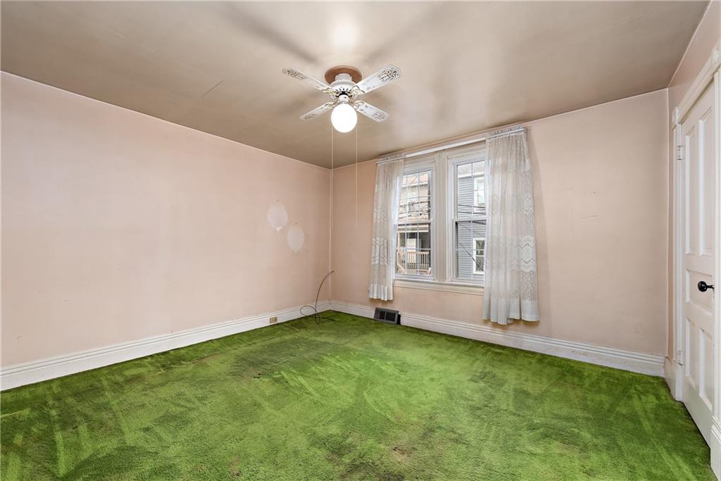 801 Frank Street McKees Rocks, PA 15136 - Photo 15 of 25 a view of an empty room with window and chandelier fan