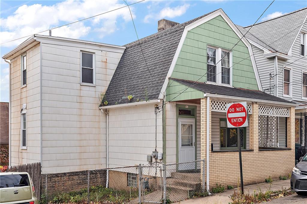 801 Frank Street McKees Rocks, PA 15136 - Photo 2 of 25 a view of a brick house with large windows