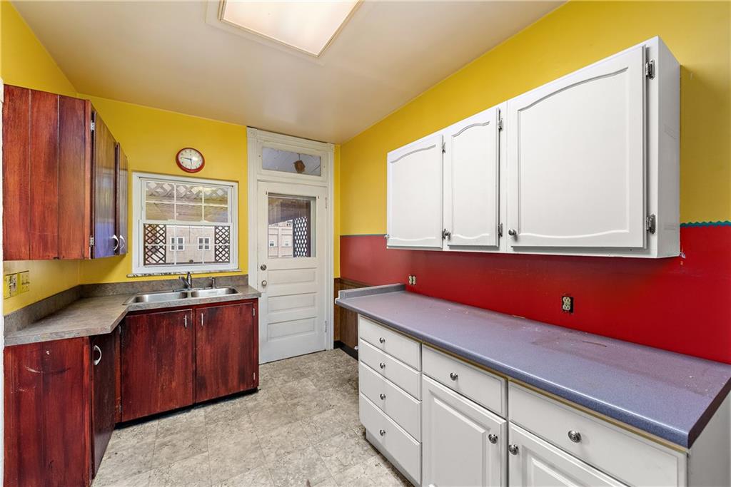 801 Frank Street McKees Rocks, PA 15136 - Photo 10 of 25 a kitchen with stainless steel appliances sink cabinets and window