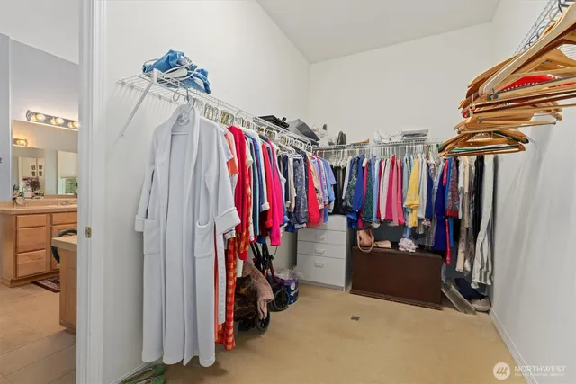 a view of walk in closet with clothes