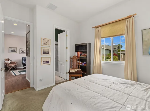 a bedroom with a bed and a large mirror