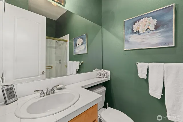 a bathroom with a sink mirror and toilet