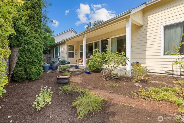 a view of a backyard with table and chairs and potted plants