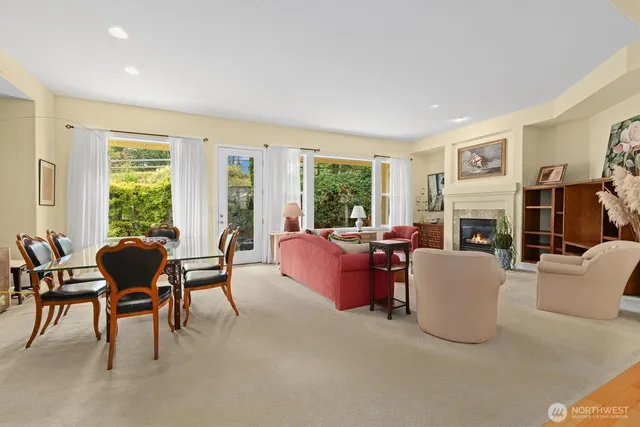 a living room with fireplace furniture and a large window