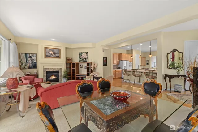 a living room with fireplace furniture and a table