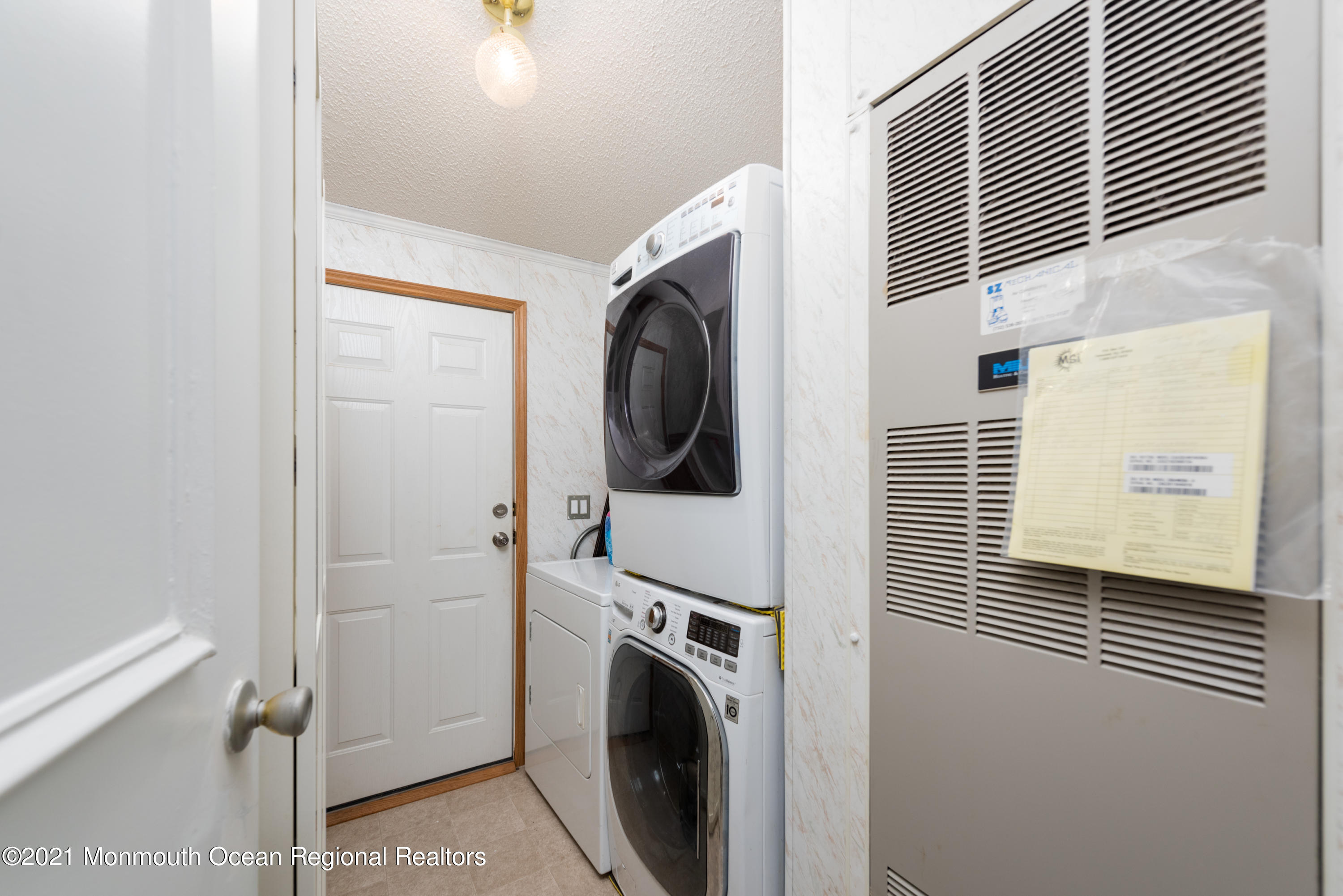90 Village Road Morganville, NJ 07751 - Photo 14 of 25 a view of a storage and utility room with washer and dryer