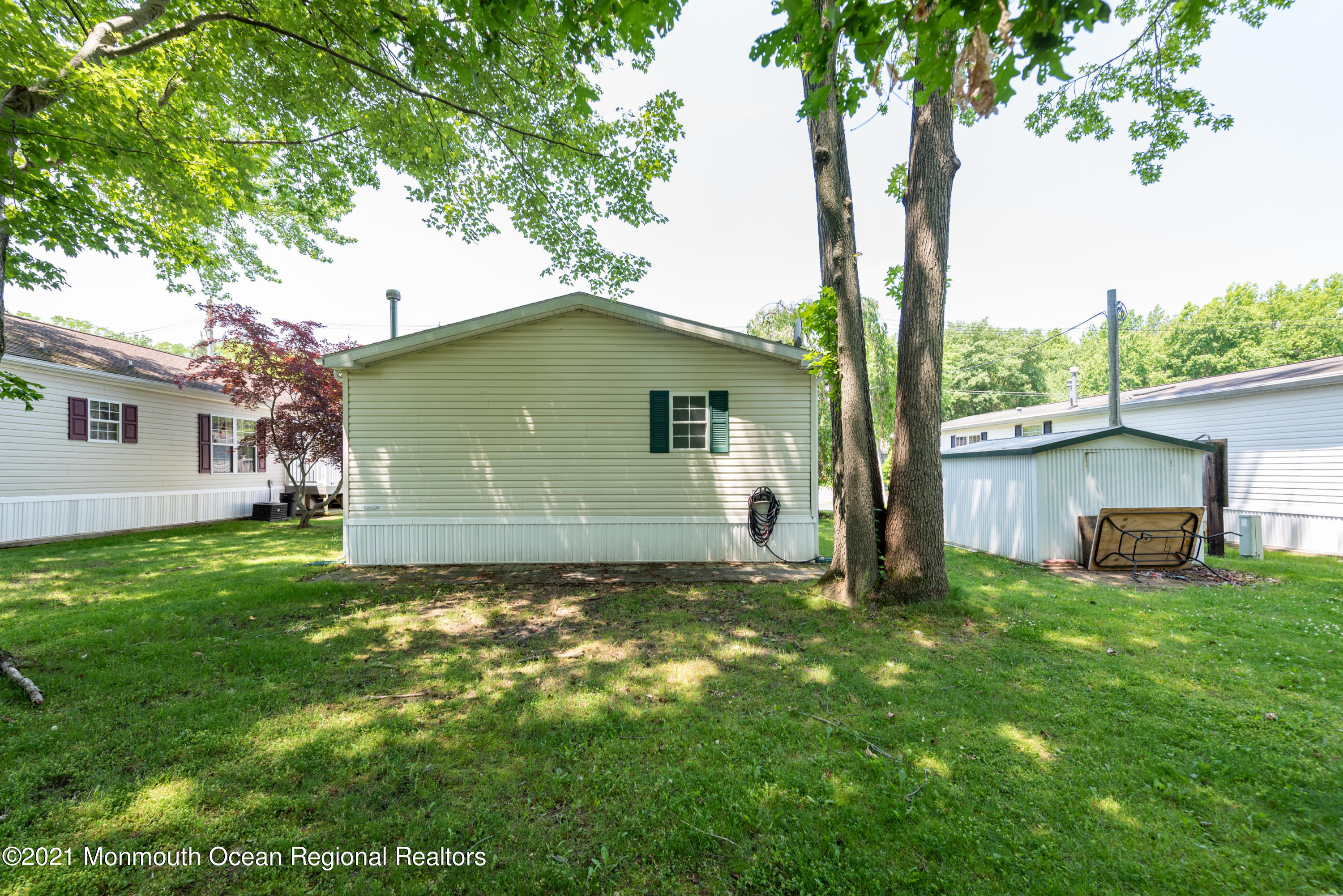 90 Village Road Morganville, NJ 07751 - Photo 22 of 25 a view of a house with a yard